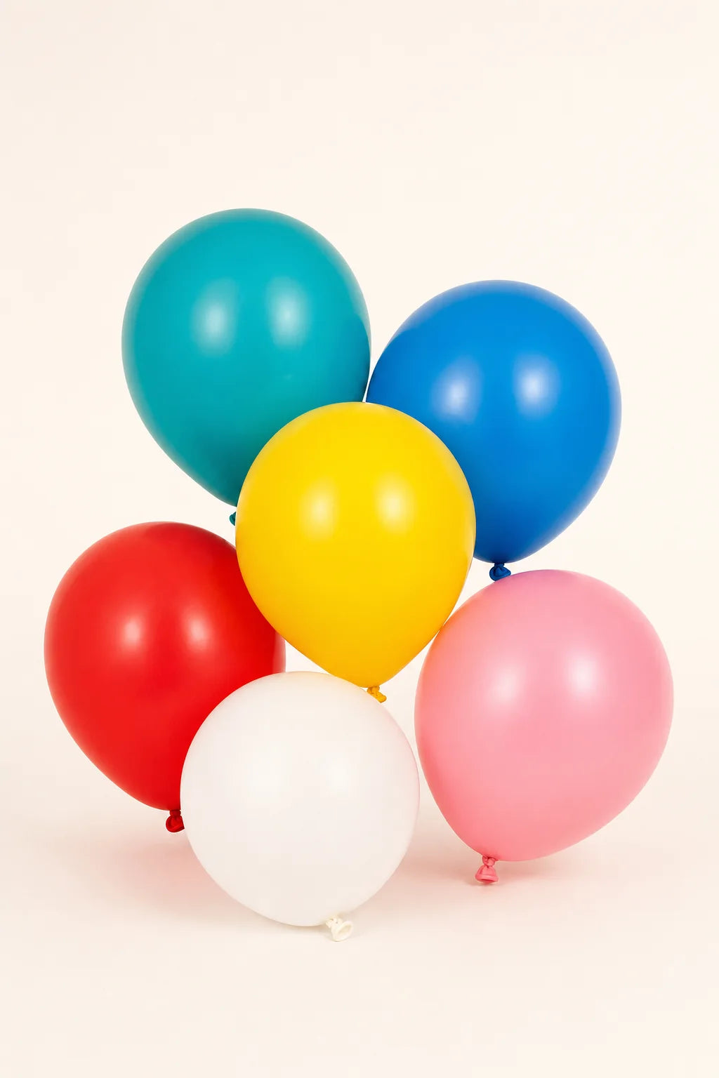 9 inch assorted plain latex balloons in a professional studio product photo