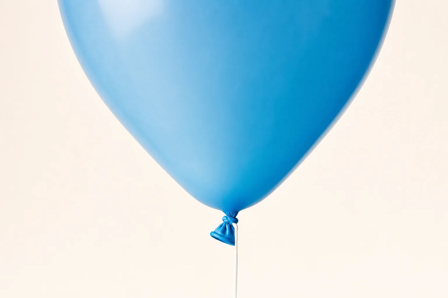 Close detail of plain helium balloon tied neck and string